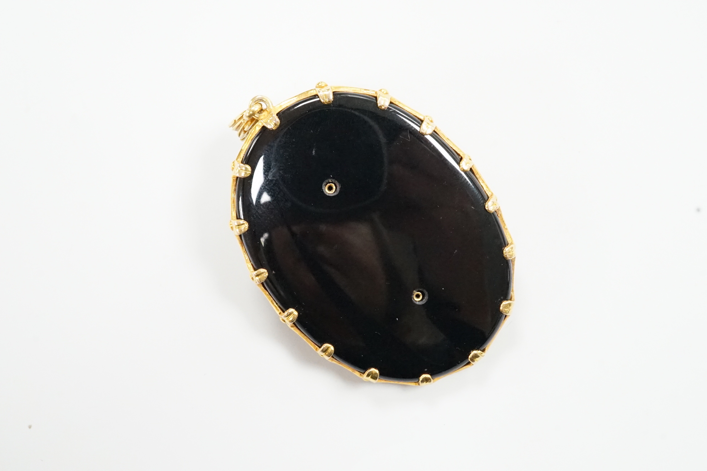 A modern 9ct gold, and diamond set black onyx pendant, decorated with the bust of a lady in relief, overall 66mm, gross weight 35.4 grams.